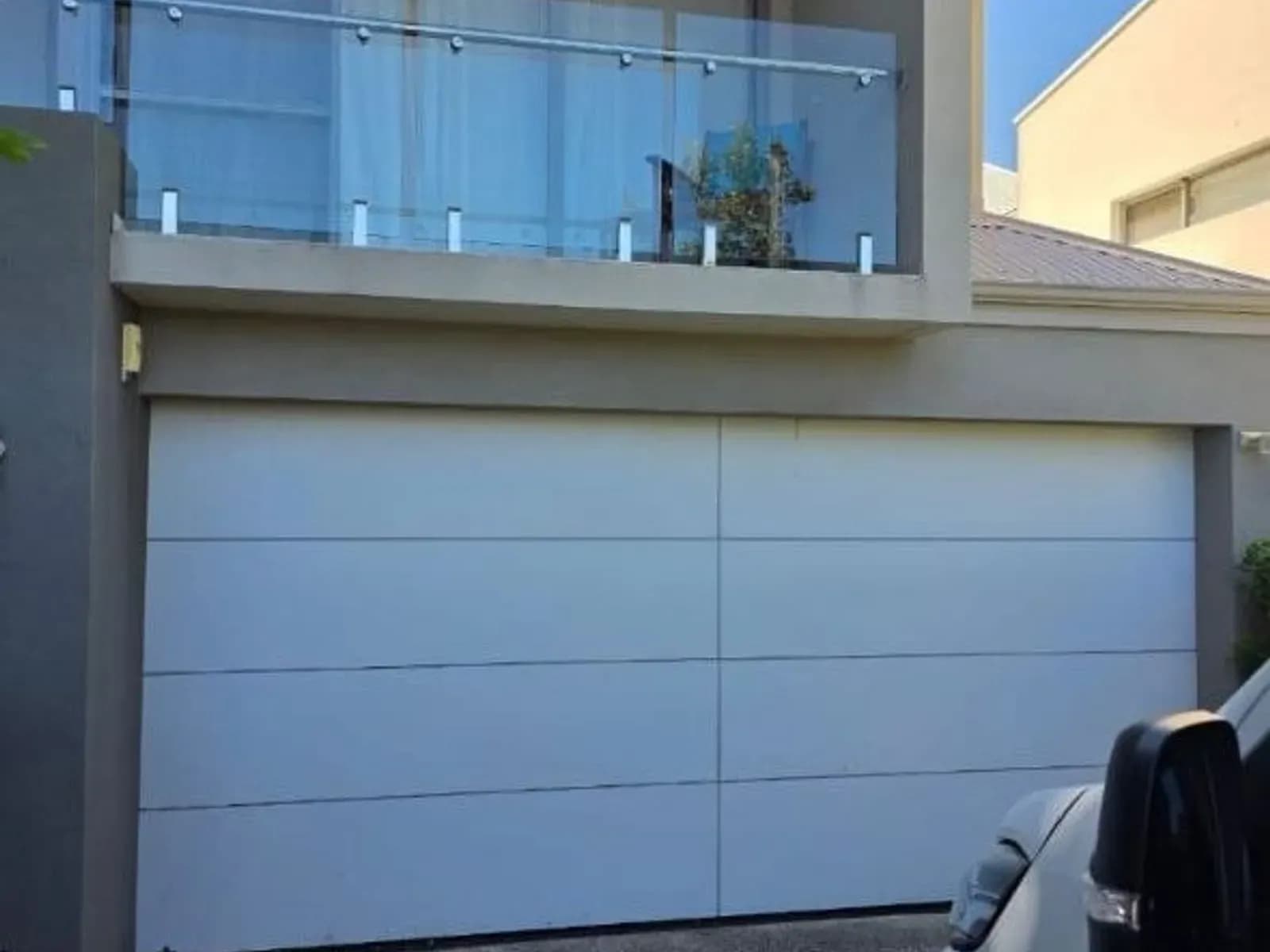 The same garage door hanging square in its opening and closing properly again