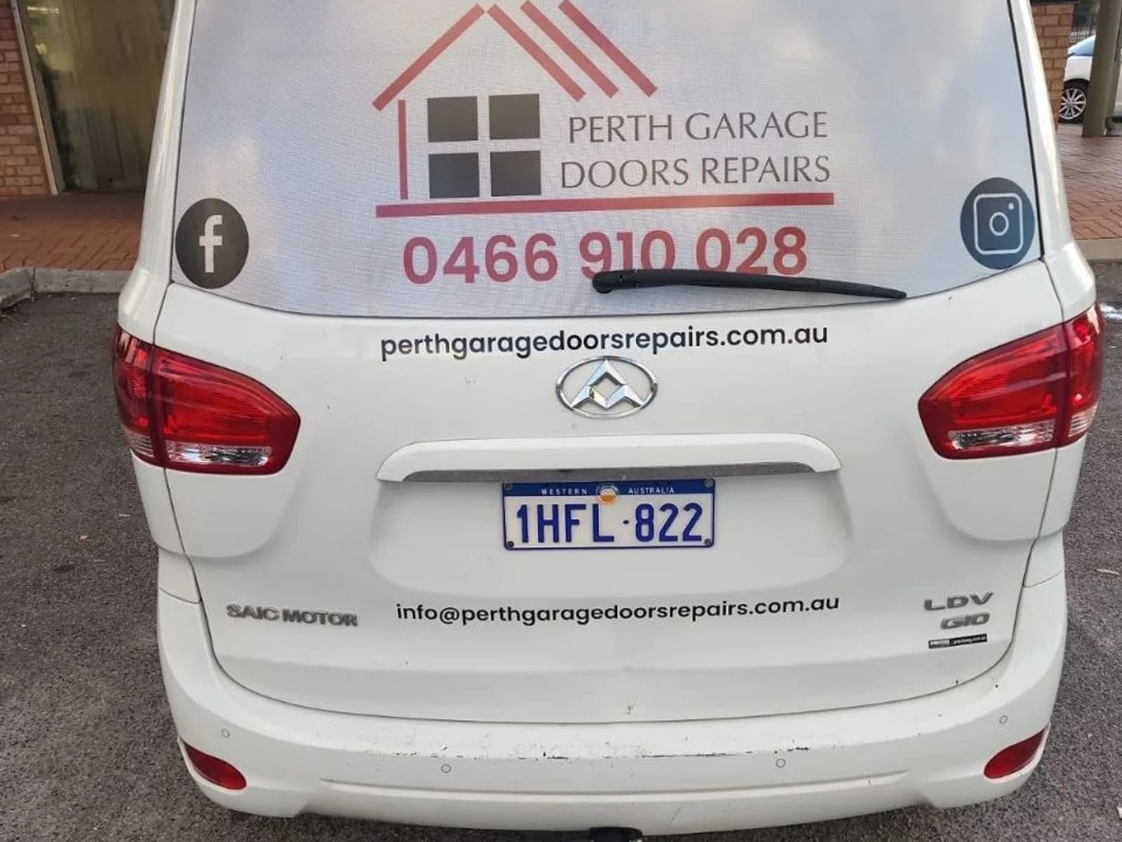 The signwritten Perth Garage Doors Repairs service van, showing the business phone number 0466 910 028