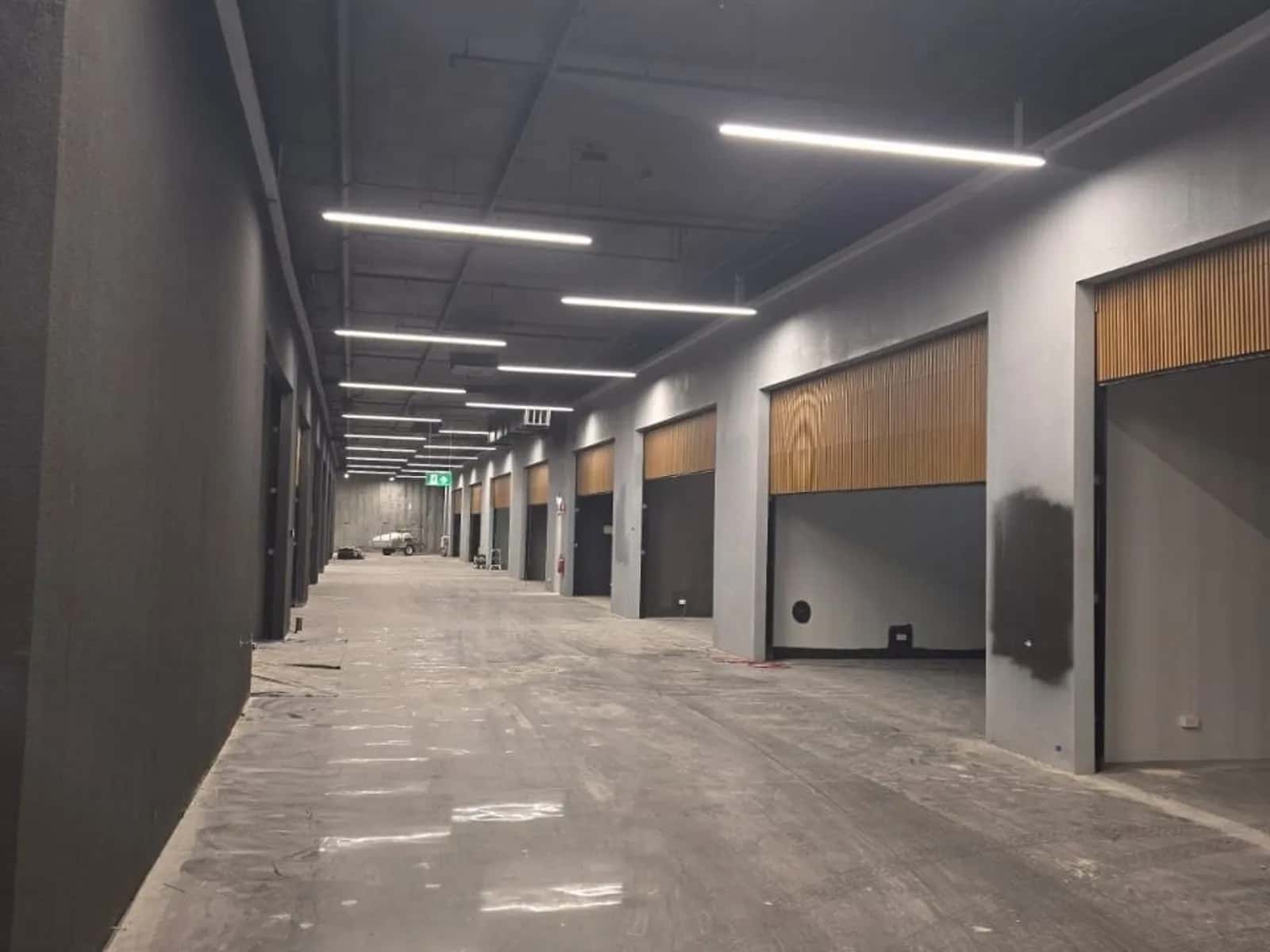 Roller shutters securing a basement carpark entry beneath a commercial building